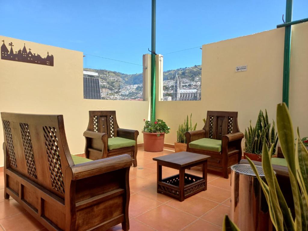 a group of chairs sitting on a patio at La Rosario Hostal in Quito