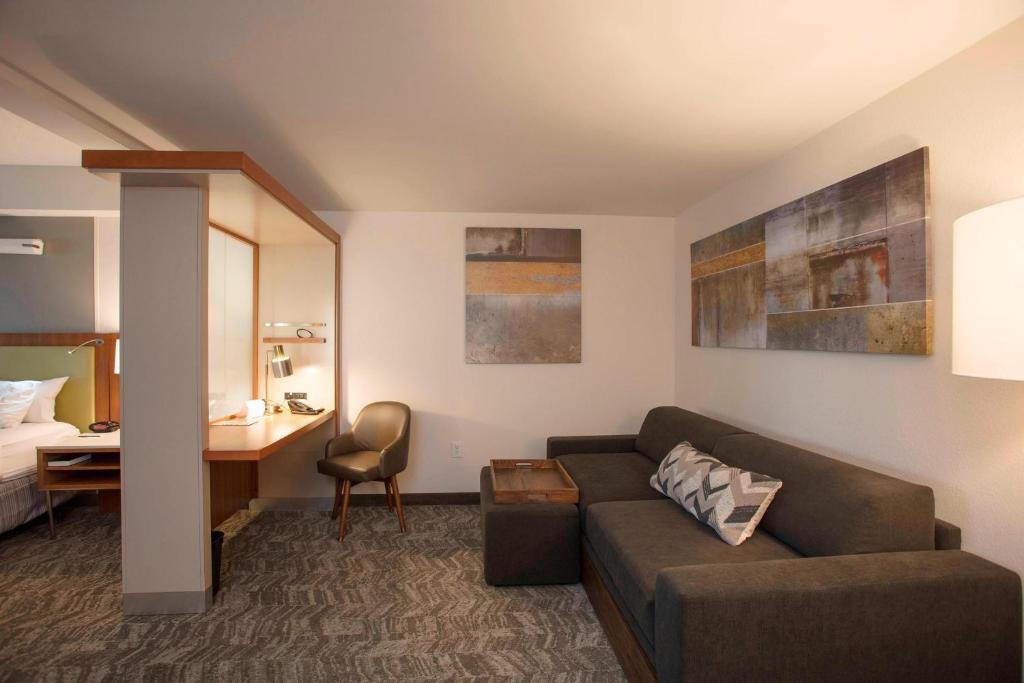 a living room with a couch and a bedroom at SpringHill Suites by Marriott Athens West in Athens
