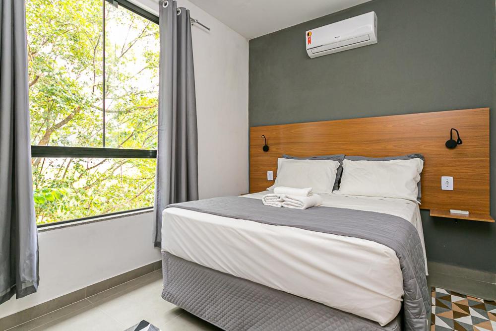 מיטה או מיטות בחדר ב-Flats das Palmeiras