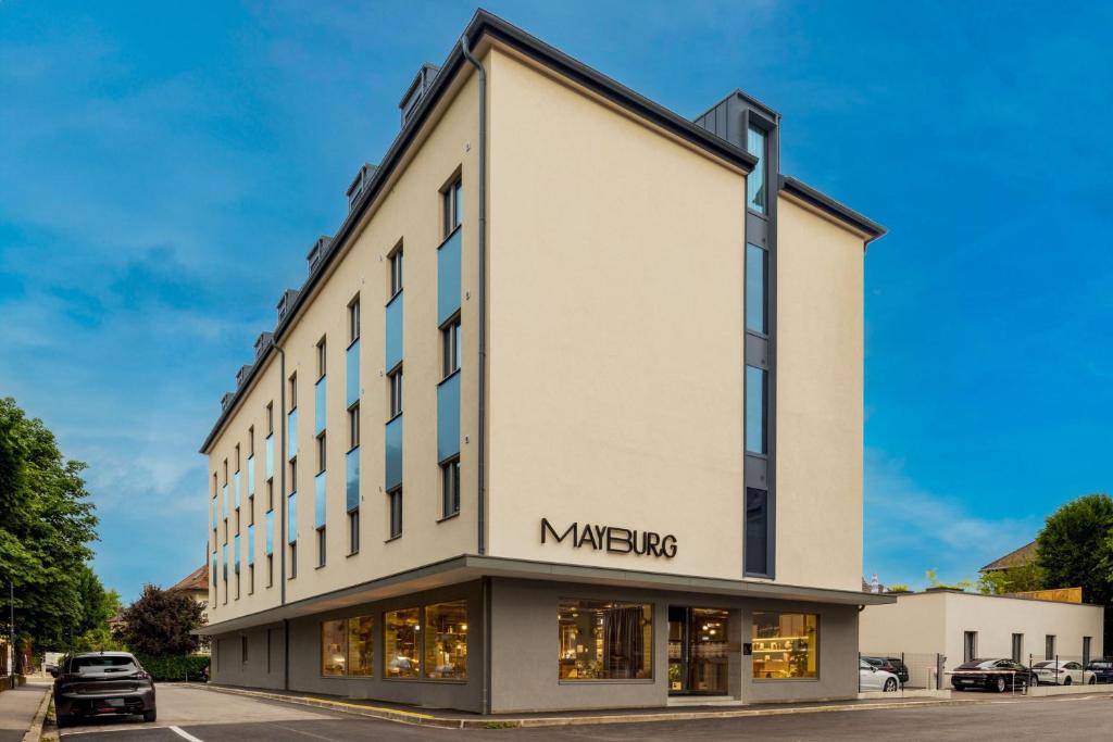um edifício com um sinal que diz meyer em Mayburg Salzburg, a Tribute Portfolio Hotel em Salzburgo