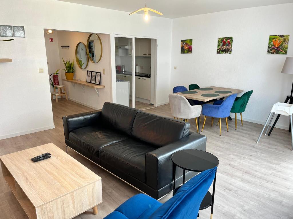uma sala de estar com um sofá de couro preto e uma mesa em Vilvoorde city center em Vilvoorde
