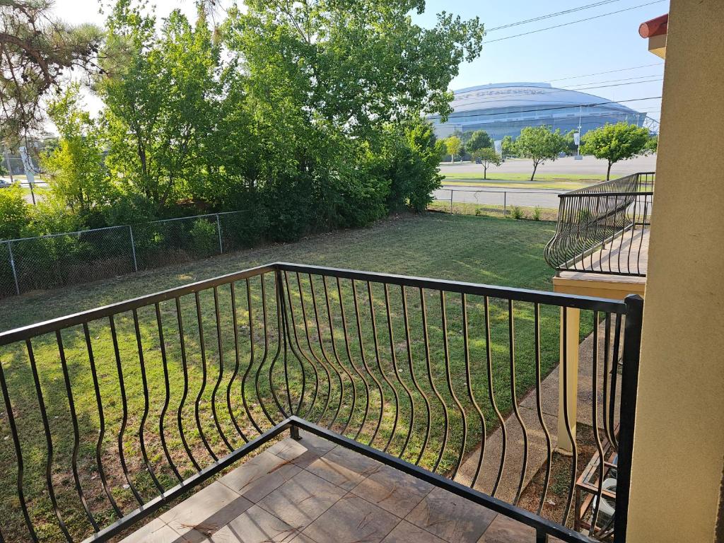 a balcony with a view of a baseball field at KING BED! Walk To AT&T Stadium, Globe Life in Arlington