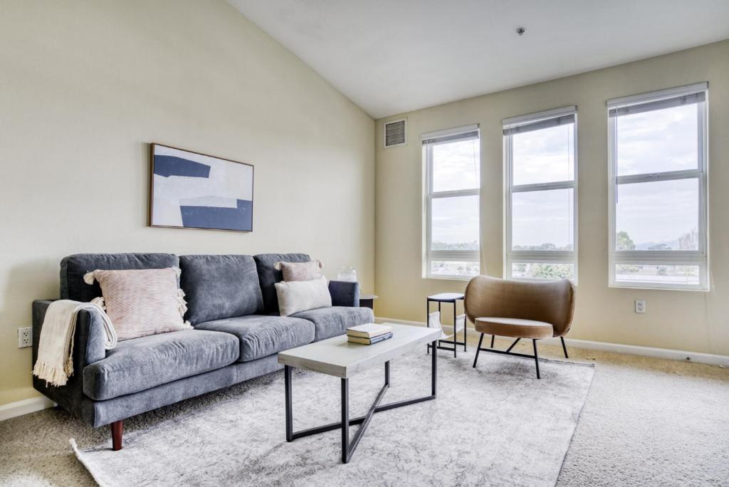 a living room with a couch and a table at San Bruno 1BR w Pool Gym WD nr highways SFO-812 in San Bruno