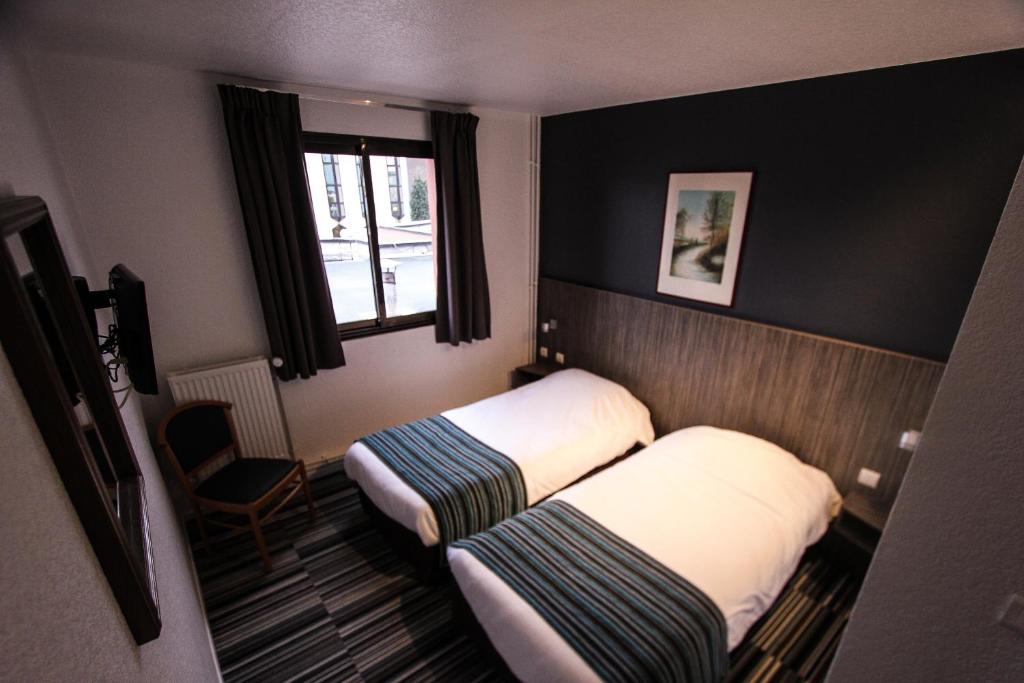 Postel nebo postele na pokoji v ubytování Hotel Bollaert