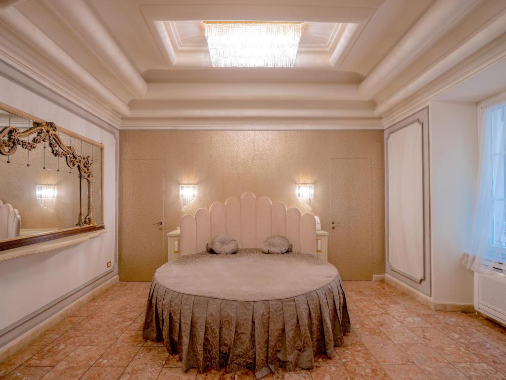 ein Schlafzimmer mit einem großen weißen Bett in einem Zimmer in der Unterkunft Casa Balzola - Suite Perla in Alassio
