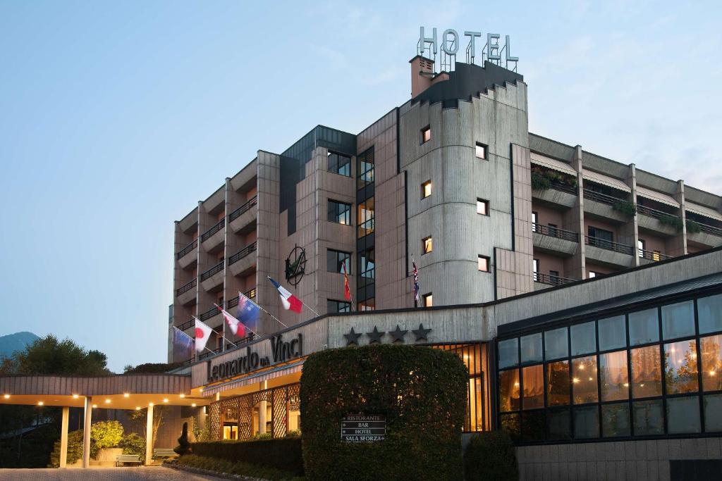 un edificio de hotel con banderas encima en Best Western Hotel Leonardo da Vinci, en Erba