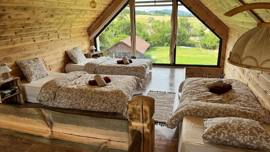 a bedroom with three beds in a room with windows at Pod Aniołem in Świerzawa