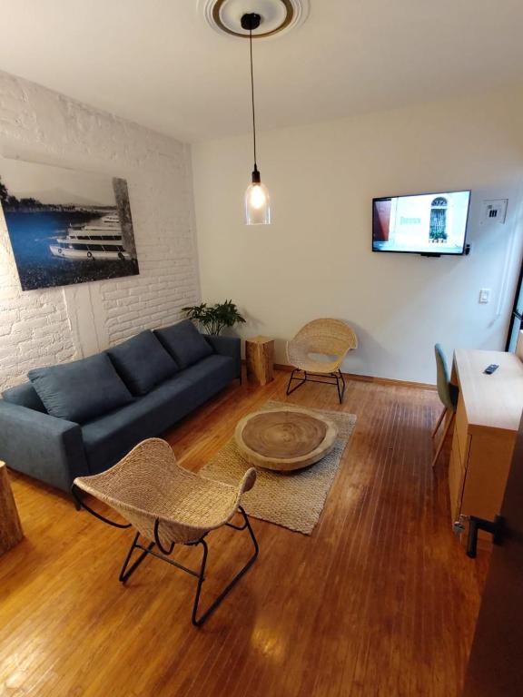 a living room with a blue couch and a table at Casa Alfredo in Mexico City