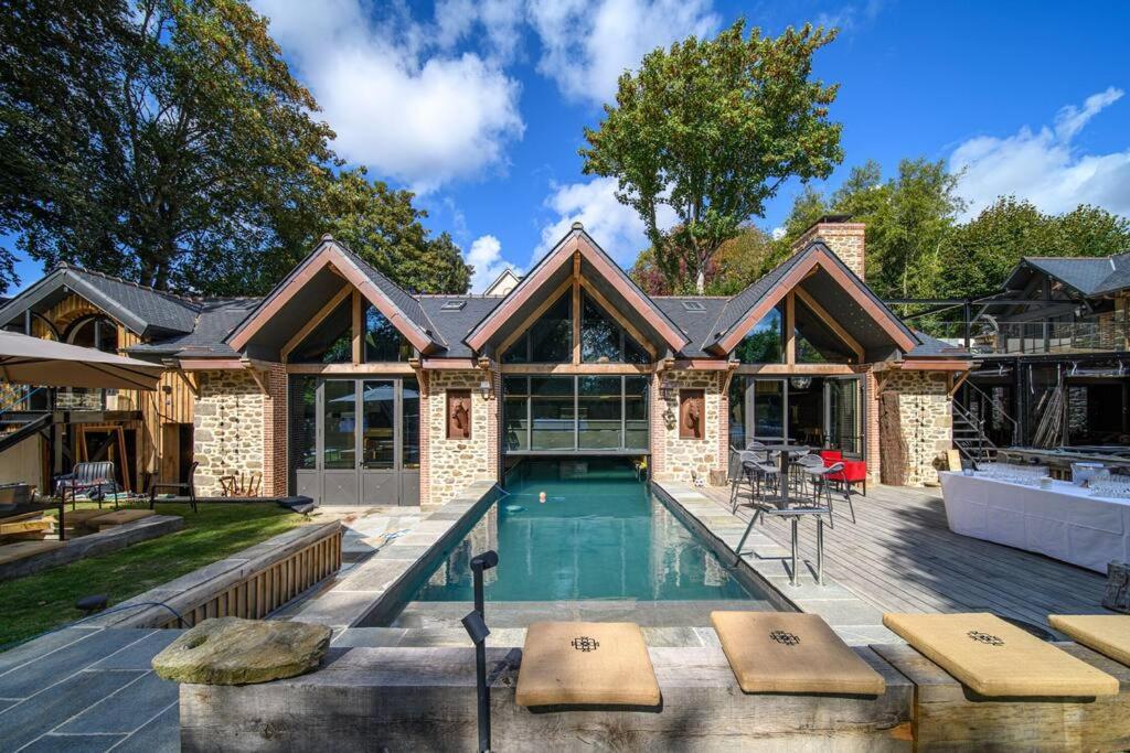 a home with a swimming pool and a house at Le Grenier sur l'Eau - Saint-Malo - St Servan in Saint Malo