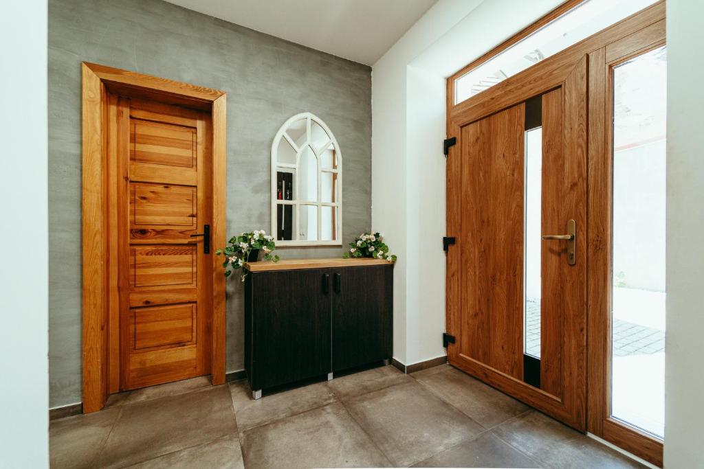 a hallway with a wooden door and a window at Luxury style apartment in Šaštín