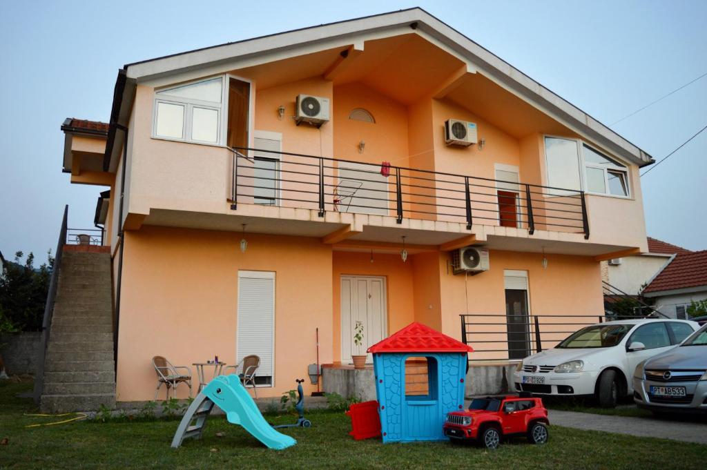 a house with a play set in front of it at House of peace in Podgorica