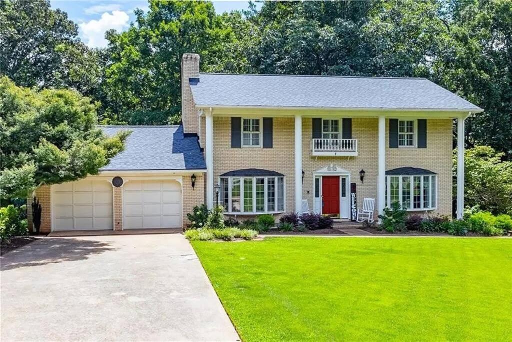 a house with a green lawn in front of it at Southern Home and fishing lake. in Gainesville