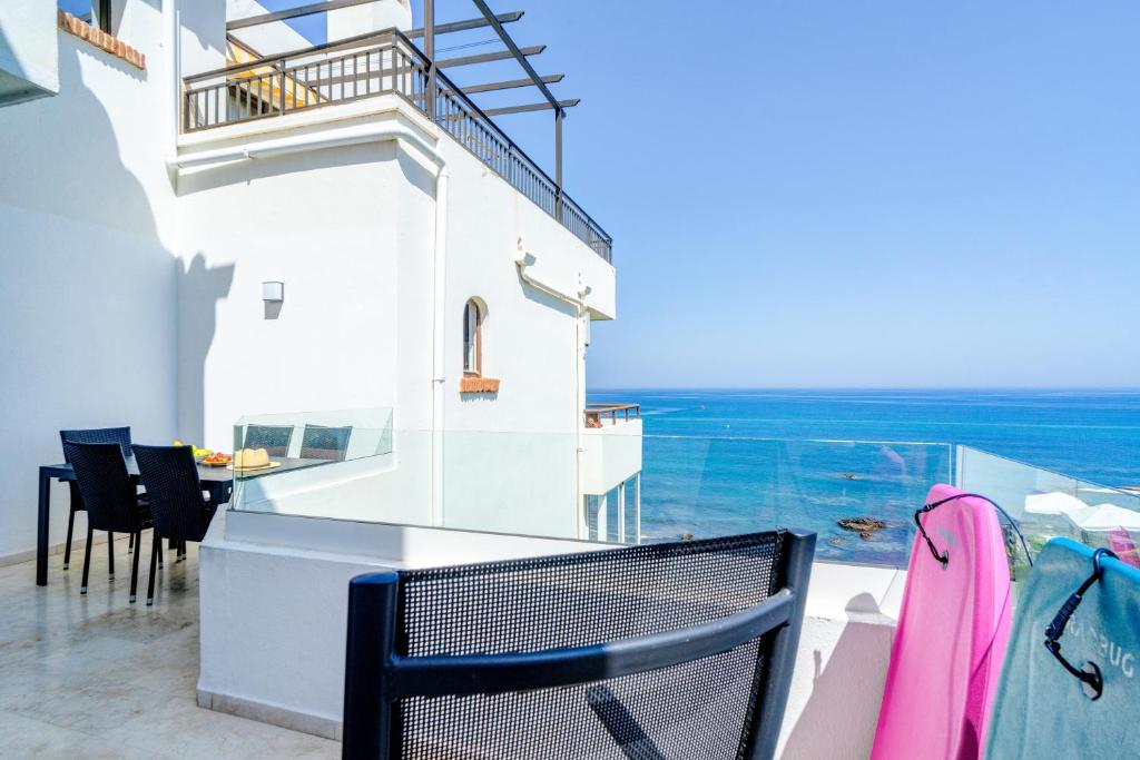 a room with a balcony with a view of the ocean at La Cala on the beach sunsets view. in La Cala de Mijas