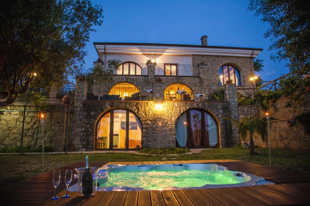 a large stone house with a pool in front of it at Antica Dimora Palinuro in Palinuro