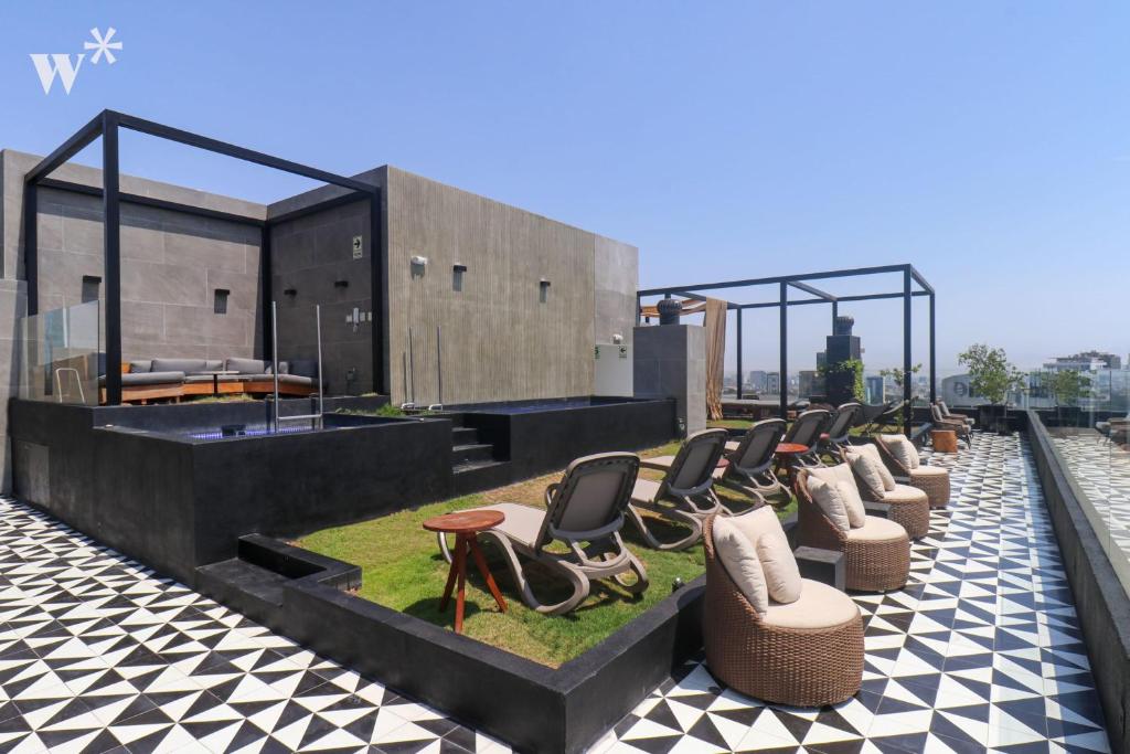 a row of chairs sitting on top of a building at Alta by Wynwood House in Lima