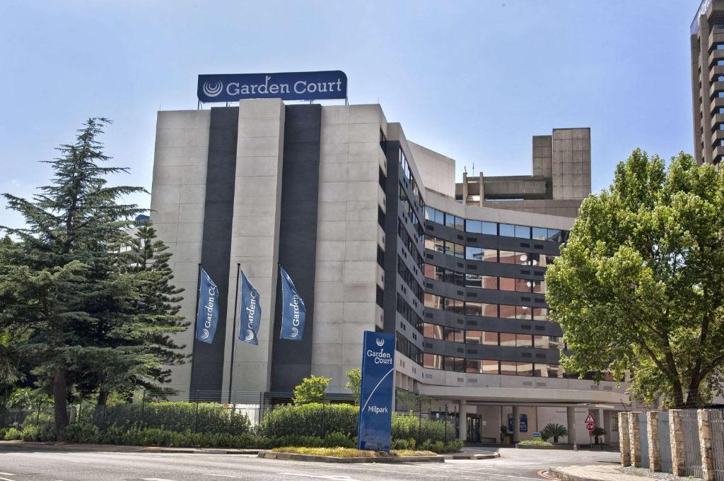 a building with blue flags in front of it at Garden Court Milpark in Johannesburg