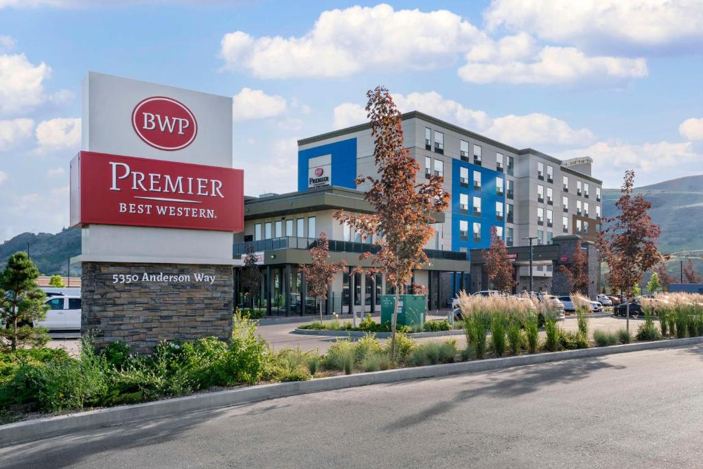 a sign for a hotel in front of a building at Best Western Premier Route 97 Vernon in Vernon