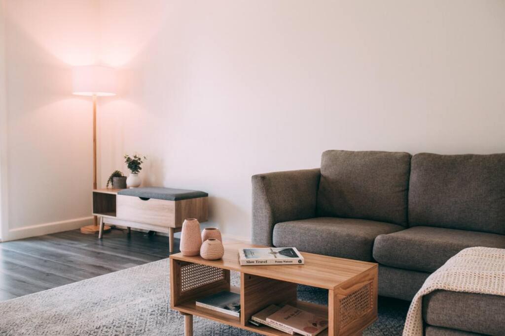 a living room with a couch and a coffee table at The Vine House - Benalla in Benalla