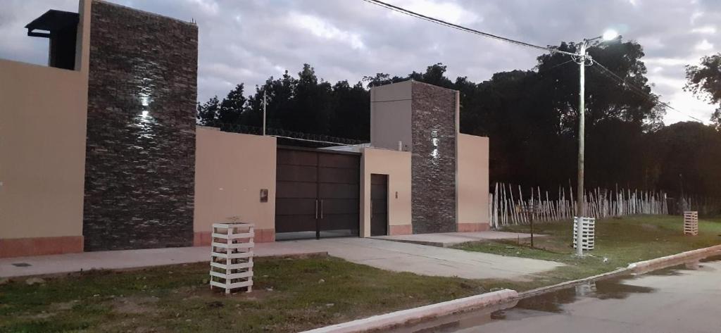 a building with two large stone towers on a street at El Solar Departamentos Tartagal in Tartagal