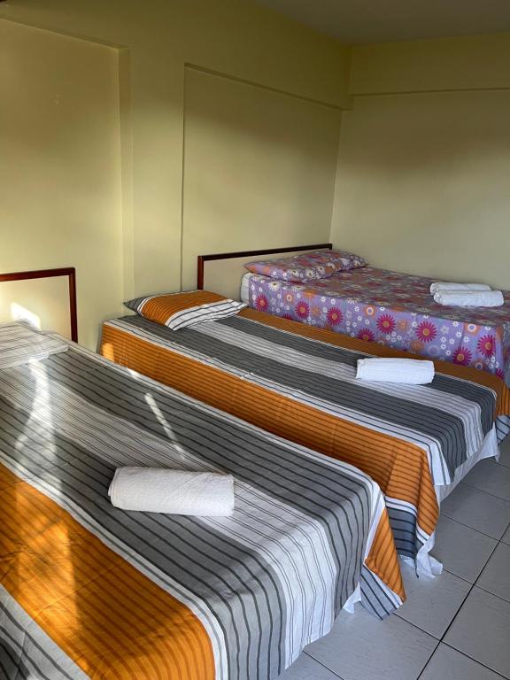 a group of three beds in a room at Royal Service Hotel - Tambaú - ap 111 in João Pessoa