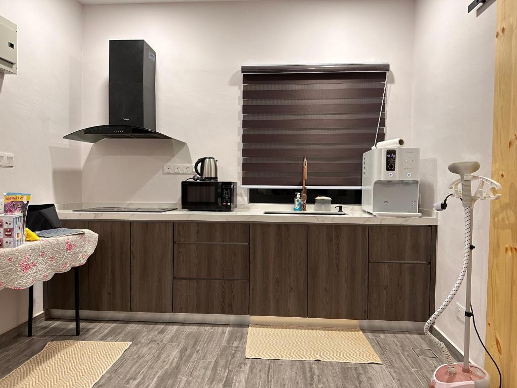 cocina con fregadero y ventana en Rumah Tamu Sonata, en Seremban