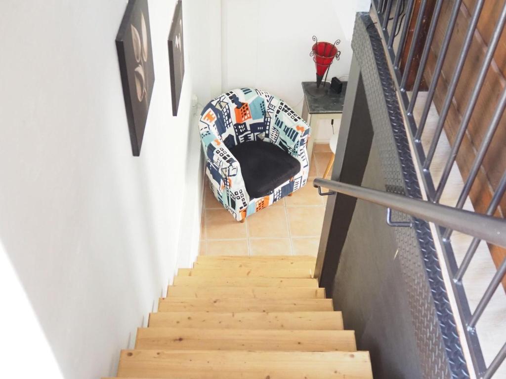 a stairway with a dog bed in a room at Small holiday home with courtyard, Bellegarde in Bellegarde