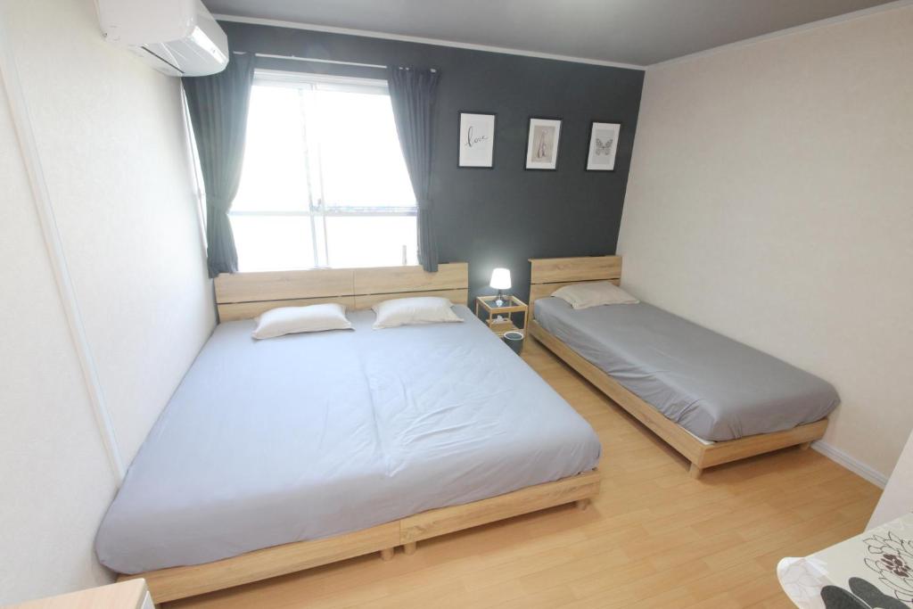 Postel nebo postele na pokoji v ubytování guesthouse みつば