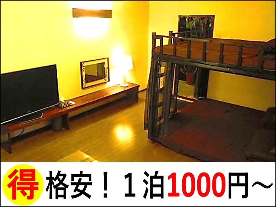 a living room with a bunk bed and a television at Stella Resort in Naha