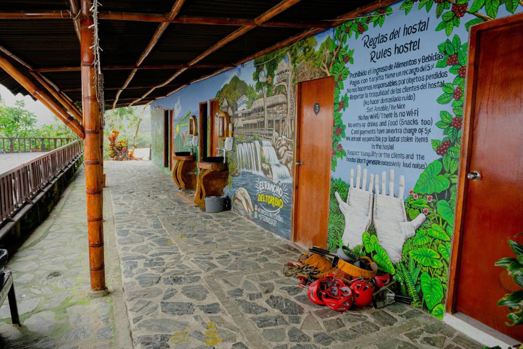a wall with a mural on the side of a building at Hostal Sierra Minca in Minca
