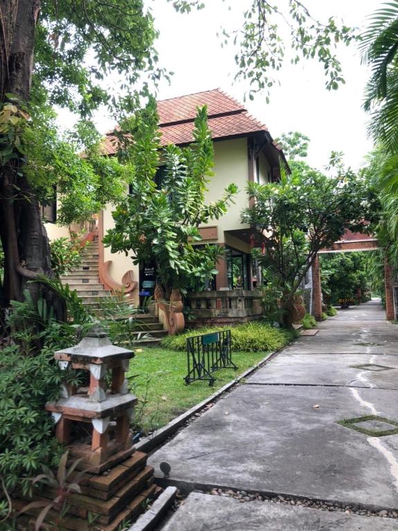 a house with a pathway in front of it at พิชชาวรี รีสอร์ท in Ban Si Thep (2)