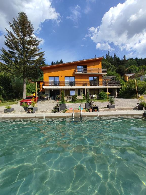 a house with a swimming pool in front of it at Dom i Las in Brenna