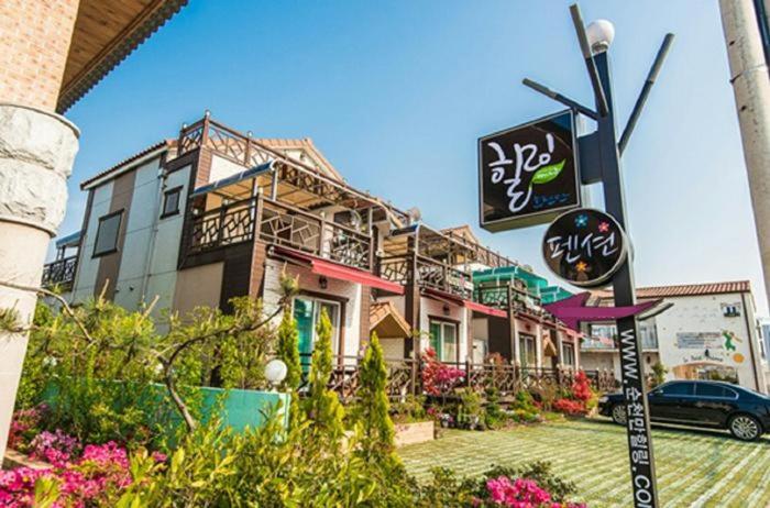 a building with a sign in front of it at Suncheon Bay Healing Pension in Suncheon