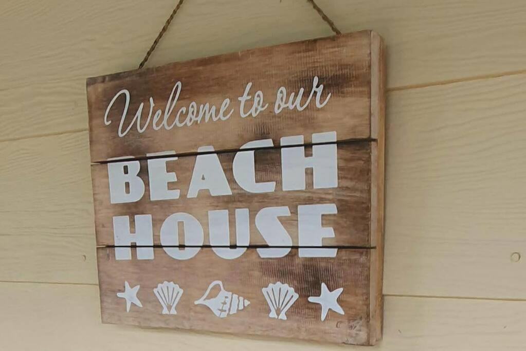 Una señal que dice bienvenida a la casa de la playa en Family Friendly Beach House, en Goolwa South