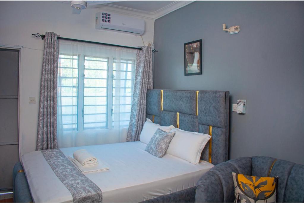 a small bedroom with a bed and a window at Emap Homes- Silver Studio in Kilifi