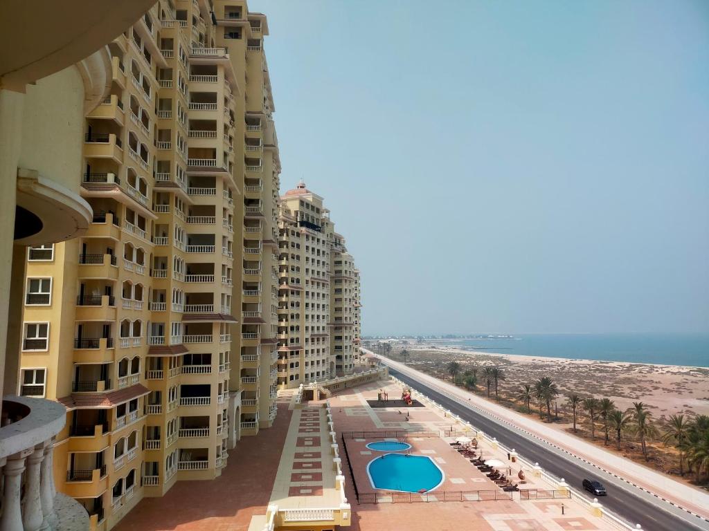 a view of the beach from the balcony of a building at Sea View Studio 3 Royal Breeze Breezeسي ويو ستوديو رويال بريز in Ras al Khaimah