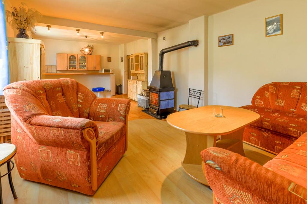 a living room with two chairs and a table at Chalupa Prášily in Prášily