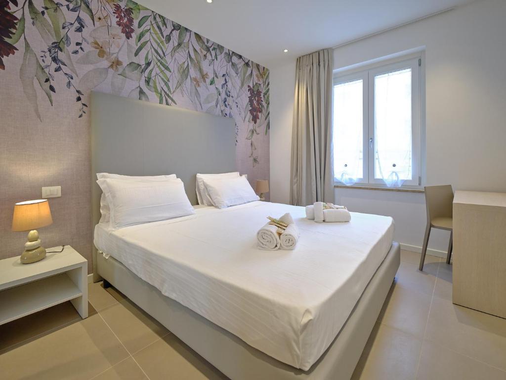 a bedroom with a bed with two towels on it at ApartmentsArena - Residenza Dei Doganieri - Verona in Verona
