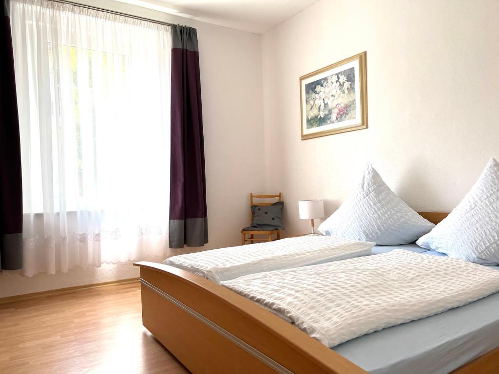 a bedroom with a bed and a large window at Schlafmütze in Plauen