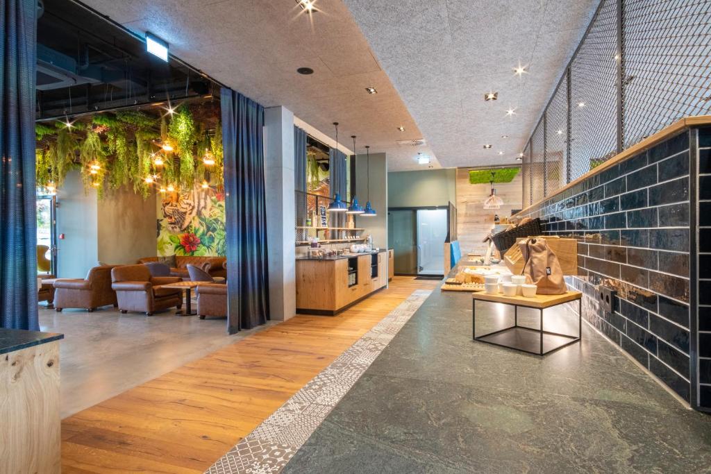 a lobby of a store with couches and a table at RiKu HOTEL Reutlingen in Reutlingen