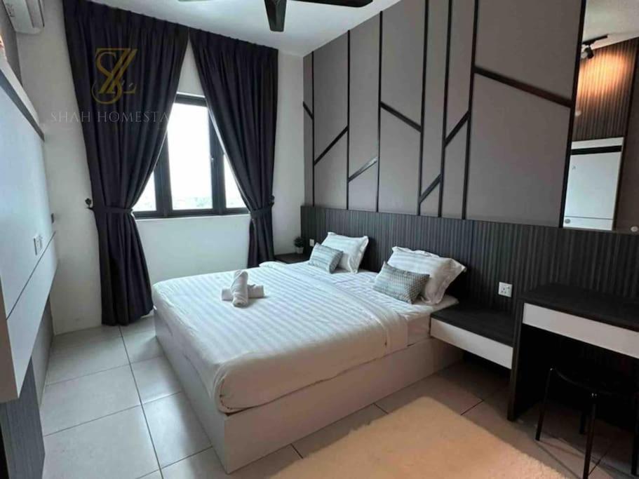 a bedroom with a large bed and a desk at SZ Home Legacy at Meritus in Perai