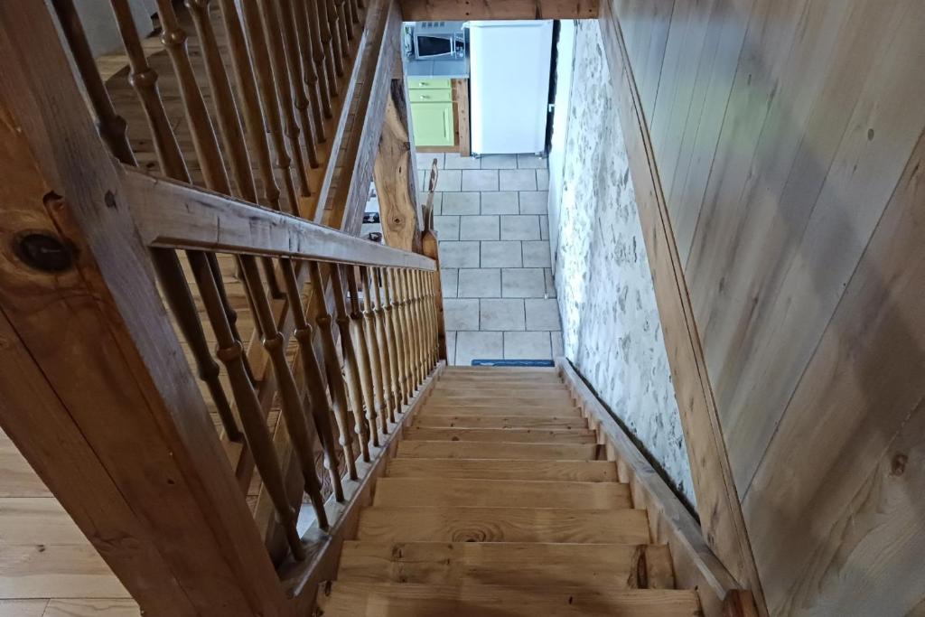 a wooden staircase leading up to the top floor of a house at Les Glycines in Saint-Pierre-de-Buzet