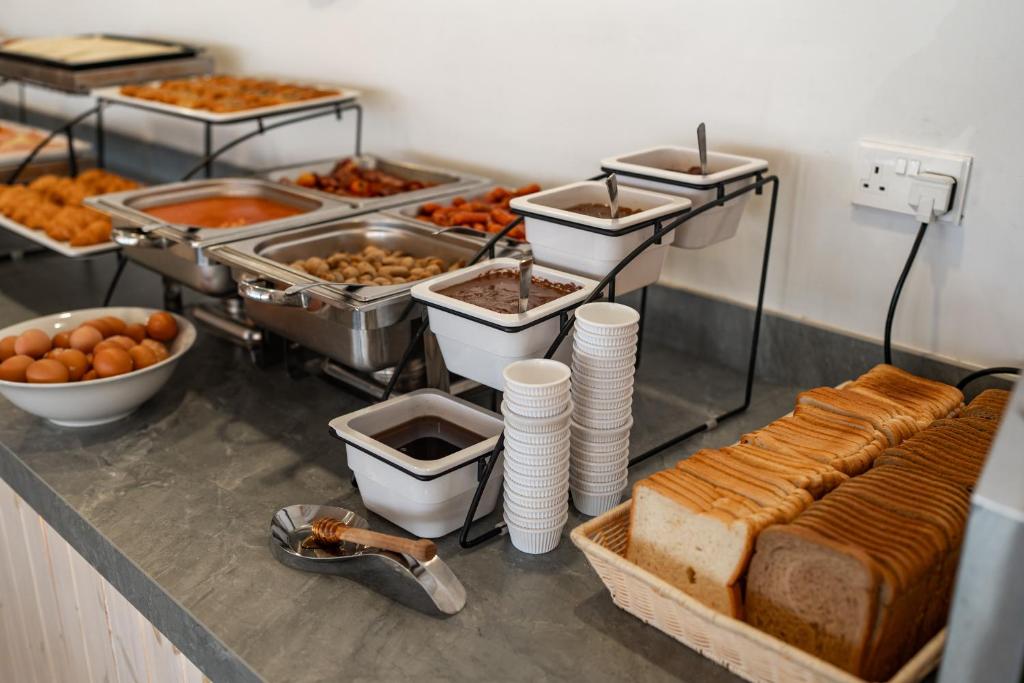 a buffet with many different types of food on a counter at Blue Harbour Boutique in Ayia Napa