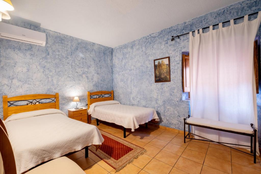 A bed or beds in a room at Rural Jordà