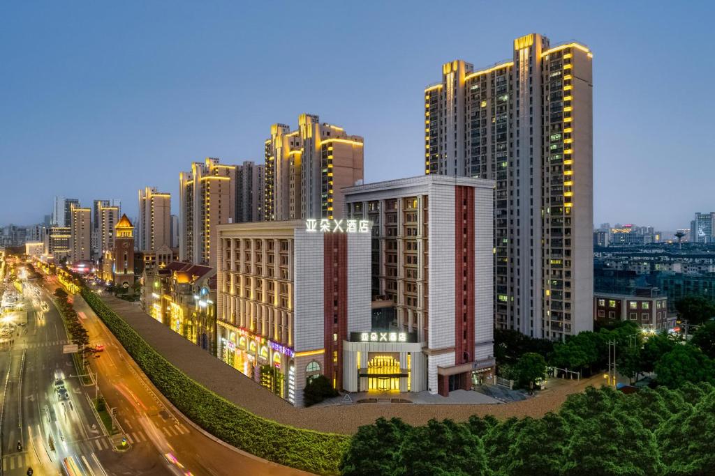 a city with tall buildings and a street at night at Atour X Hotel Wuxi Binhu Sports Center in Wuxi
