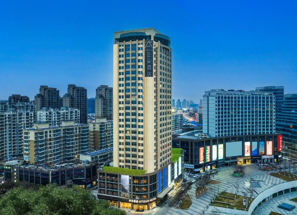 a tall building in the middle of a city at Atour Hotel Suqian West Lake Road Golden Eagle Plaza in Suqian