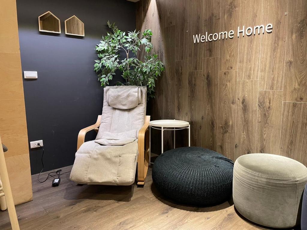 a wellness room with a chair and a plant at Yomi Hotel - ShuangLian MRT in Taipei