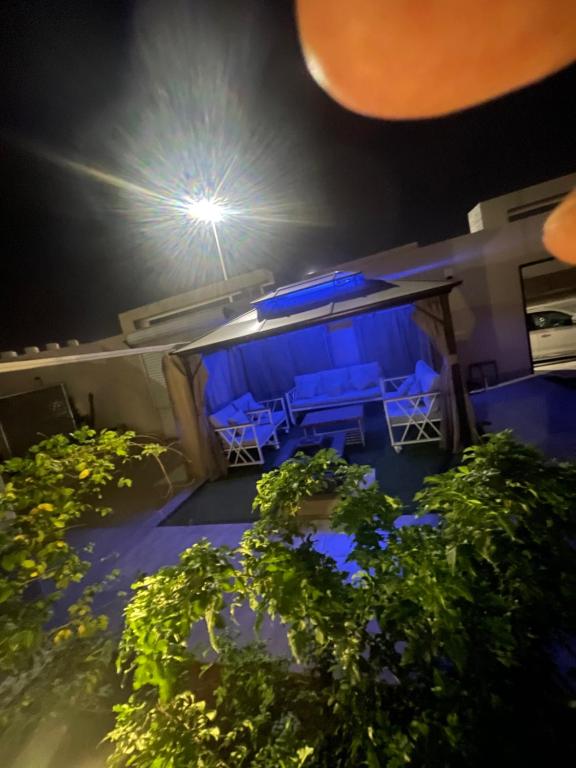 a view of a patio at night with blue lights at شاليه دانة الرس in Ar Rass