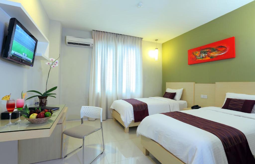 Postel nebo postele na pokoji v ubytování Lombok Plaza Hotel and Convention