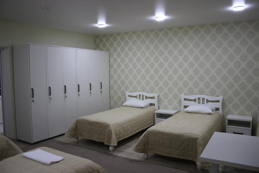 a hospital room with two beds and a cabinet at Hostel VinoGrad in Haysyn