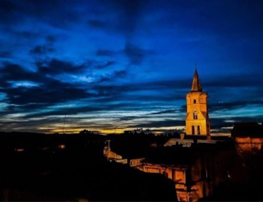 a tall building with a clock tower at night at Gite de la tour, proche Nîmes ,Avignon in Montfrin